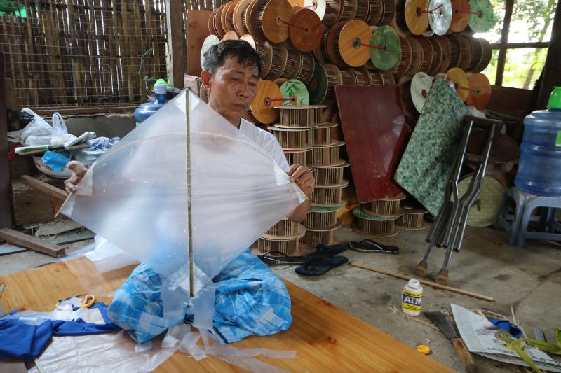 Myint Maung lost the use of his right feet after making kites and reels for decades