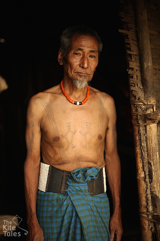 Ngòm Pok wears a traditional belt, his prized possession